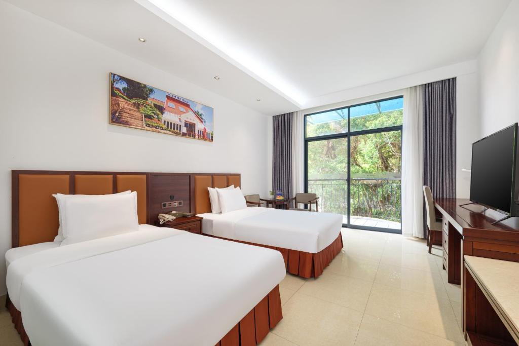 Postel nebo postele na pokoji v ubytování Xiamen Kulangsu Resort Hotel