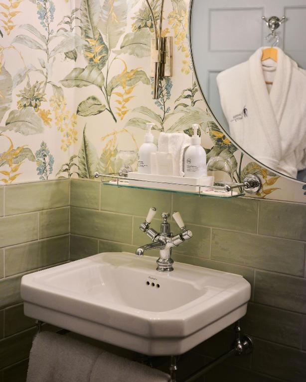 a bathroom with a sink and a mirror at The Queensberry Hotel in Bath