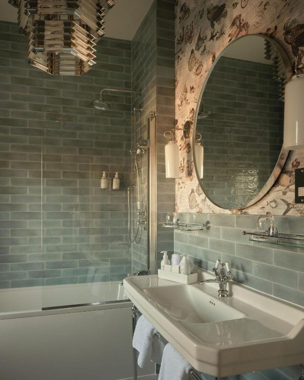 a bathroom with a sink and a mirror at The Queensberry Hotel in Bath