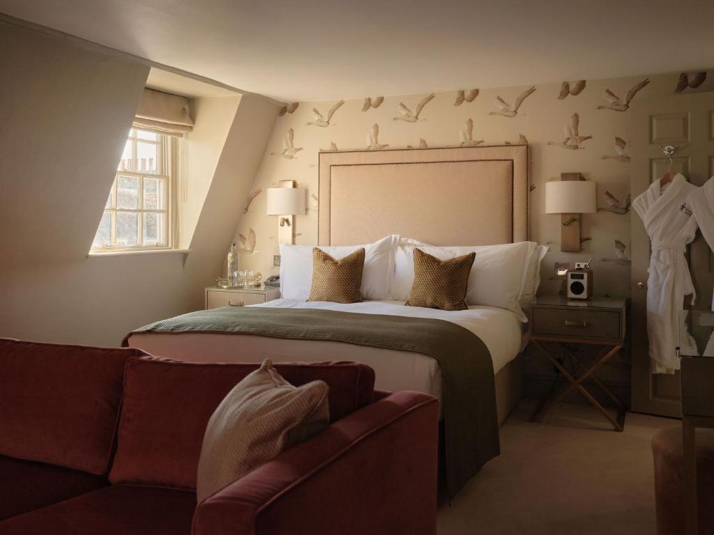 a bedroom with a large bed and a couch at The Queensberry Hotel in Bath