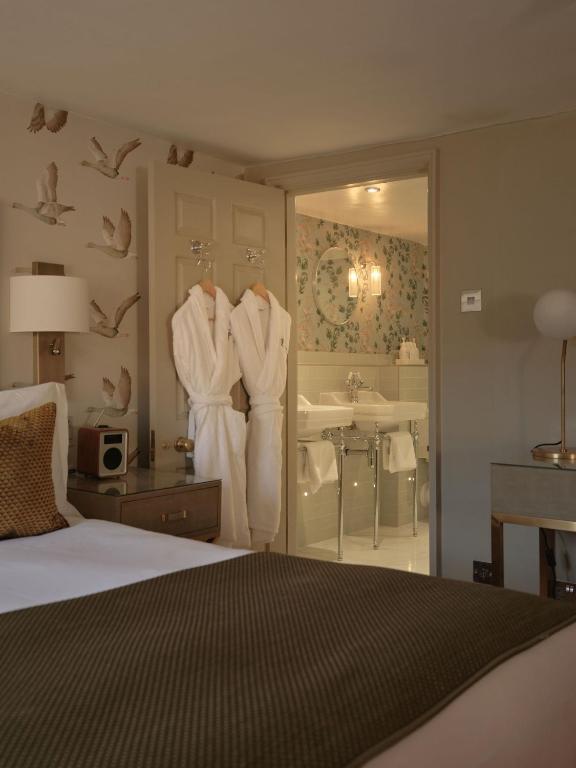 a bedroom with a bed and a bathroom with a sink at The Queensberry Hotel in Bath