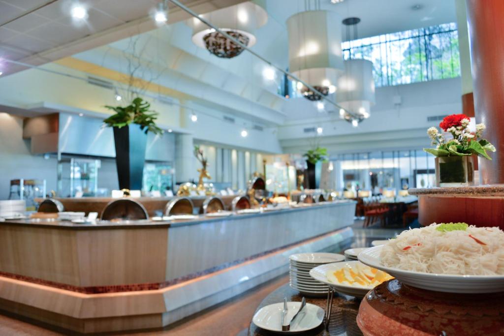 A close view of a hotel buffet with plated food and long serving counters.