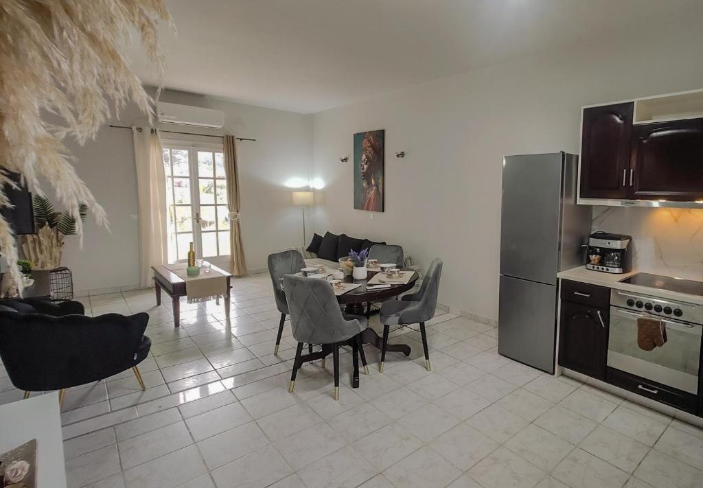 a kitchen and dining room with a table and chairs at Spiros House in Roda