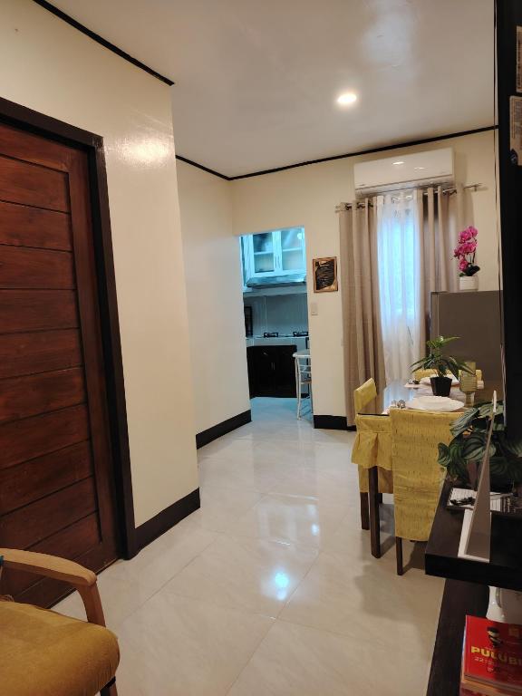 a living room with a table and a dining room at Cozy Bella in Jalajala