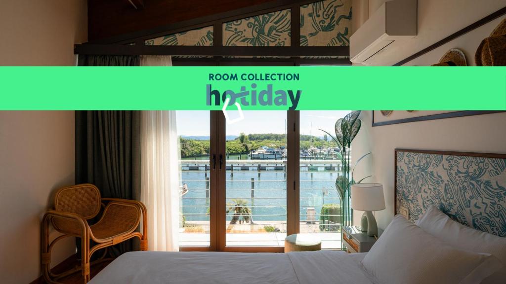 Postel nebo postele na pokoji v ubytování HOTIDAY Room Collection - Grado