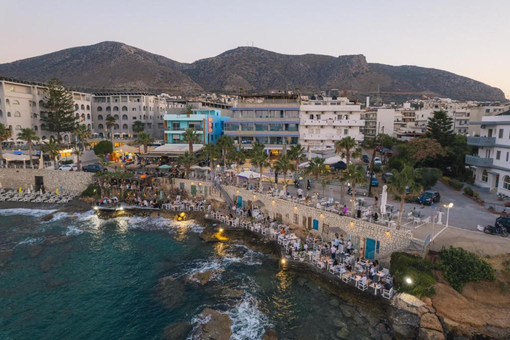 a group of people standing on a pier near the water at Glaros Royal Beach Hotel in Hersonissos