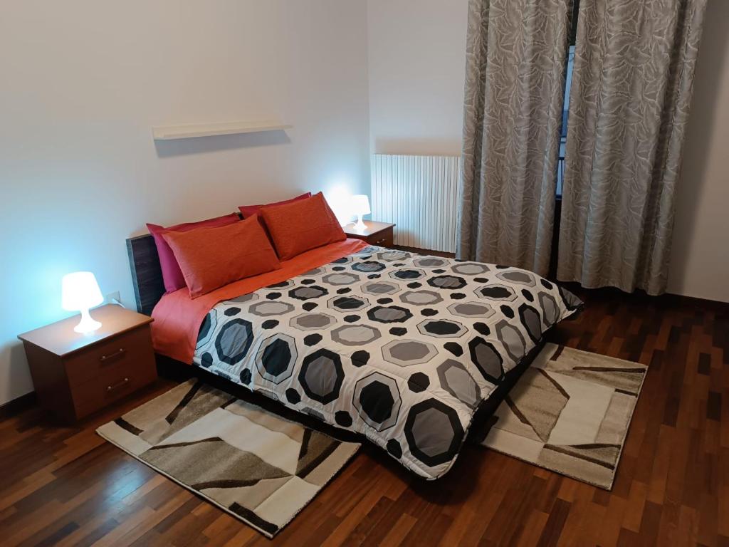 a bedroom with a bed with two tables and two lamps at Gladys in Pesaro