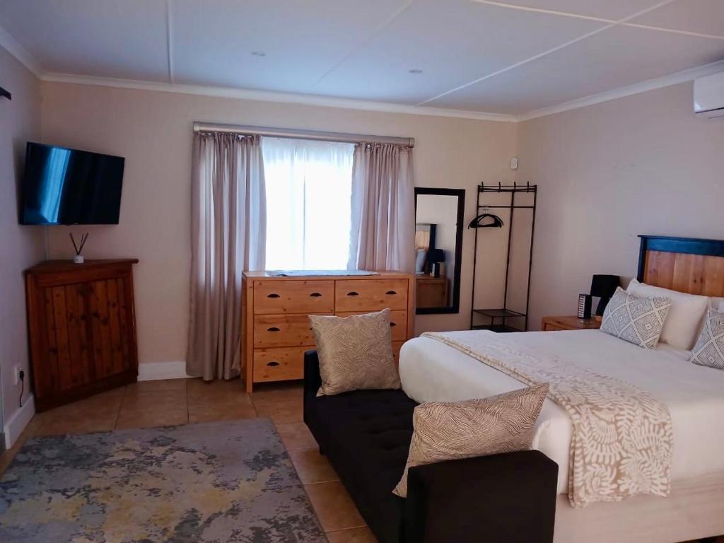 a bedroom with a large bed and a television at The Starling Room in East London