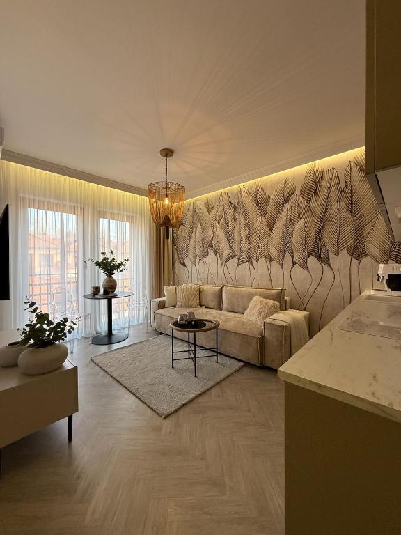 a living room with a couch and a table at Apartament Pod Żaglami 1 in Sława