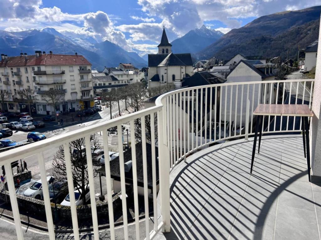 a balcony with a view of a city and mountains at Le balcon du Hautacam in Argelès-Gazost