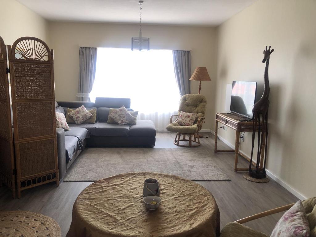 a living room with a couch and a table at Sonneneck 7 in Swakopmund