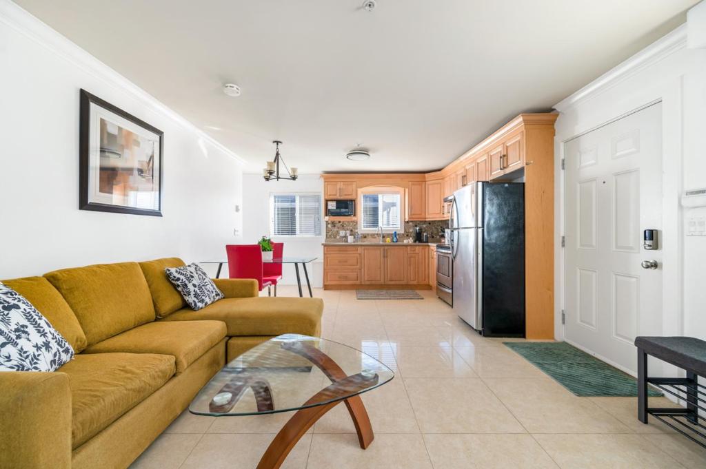 a living room with a couch and a table at Spacious and Modern Comfort Retreat in Heart of Vancouver in Vancouver