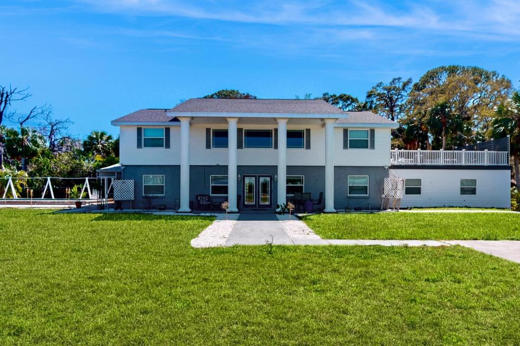 a large white house with a large yard at Blue Shores in Port Richey