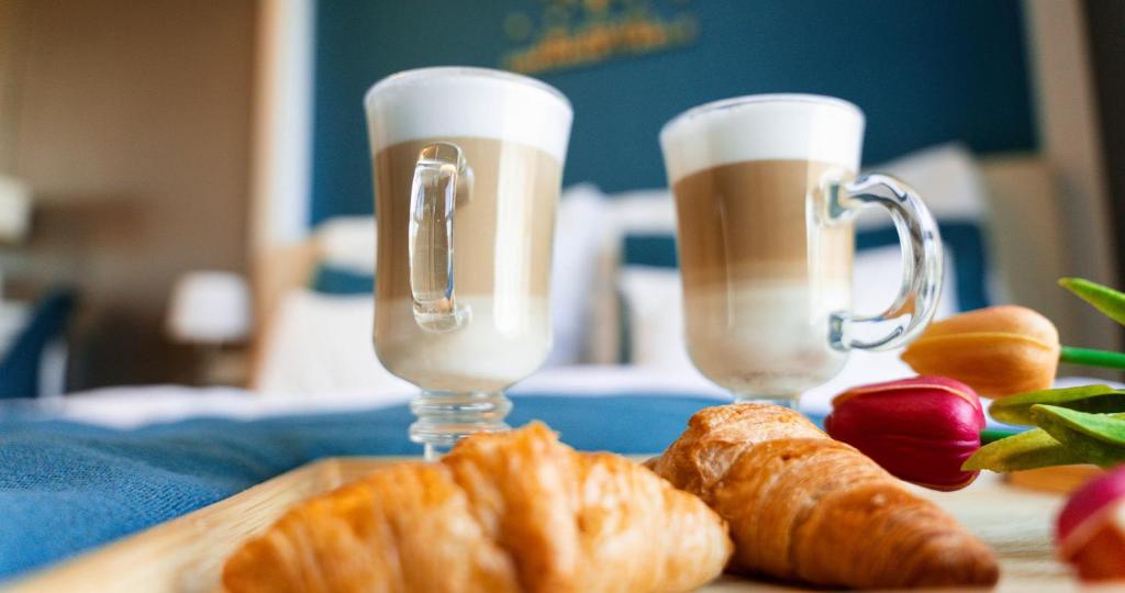 two glasses of champagne and croissants on a table at The Hotel Unforgettable - Hotel Tiliana by Homoky Hotels & Spa in Budapest