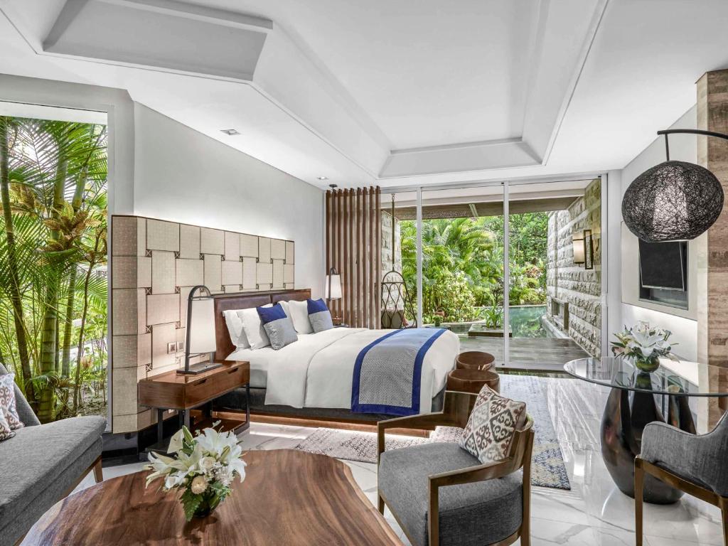a bedroom with a bed and a living room at Sofitel Bali Nusa Dua Beach Resort in Nusa Dua
