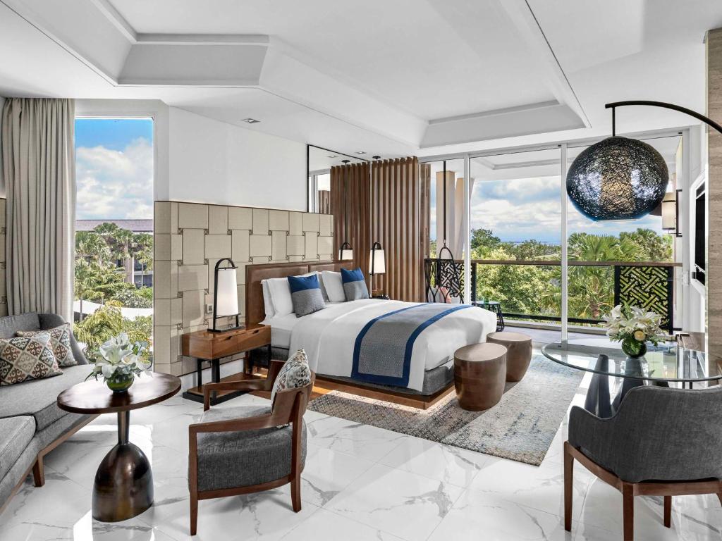 a bedroom with a bed and a living room at Sofitel Bali Nusa Dua Beach Resort in Nusa Dua
