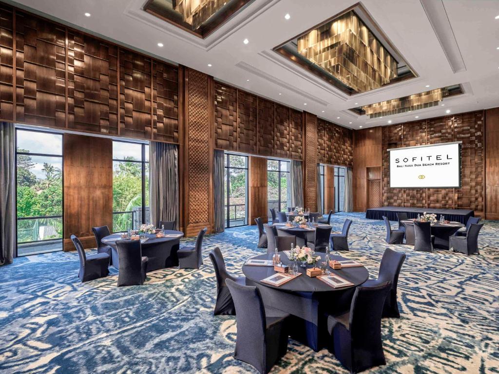 a conference room with tables and chairs and windows at Sofitel Bali Nusa Dua Beach Resort in Nusa Dua