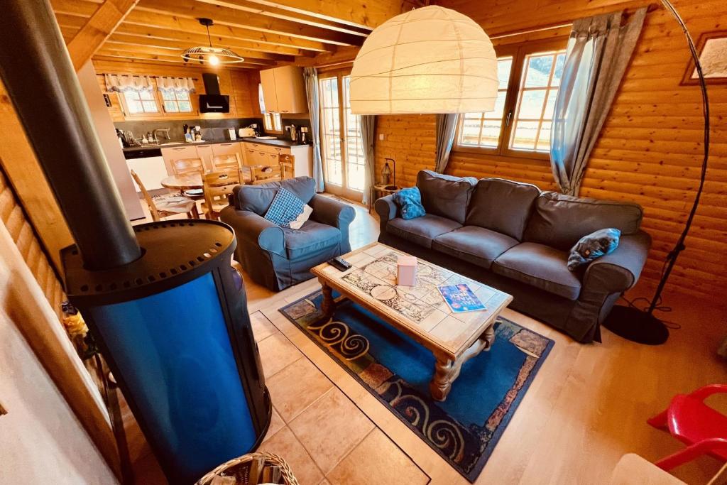 an aerial view of a living room with a stove at BEAUTIFUL CHALET in nature near Gerardmer! in Rochesson