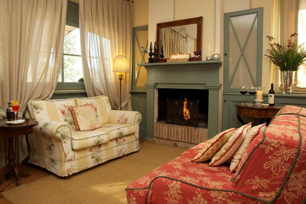 a living room with a couch and a fireplace at Albergo La Fontanella in San Casciano dei Bagni
