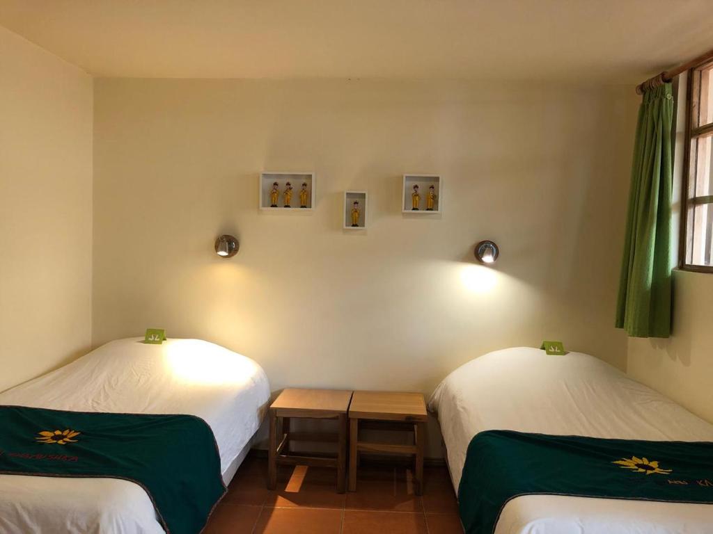 Postel nebo postele na pokoji v ubytování Inti Sisa Art Guesthouse