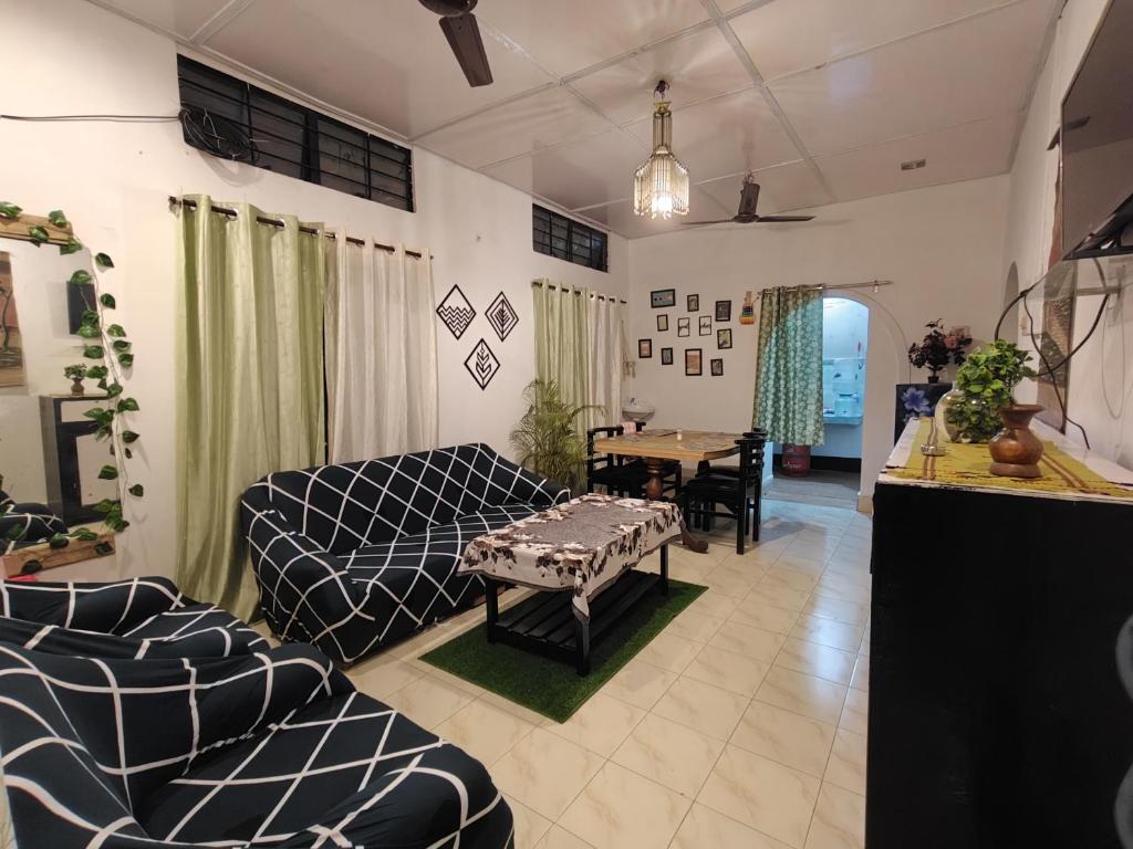 a living room with a couch and a table at Riverdale Nest in Guwahati
