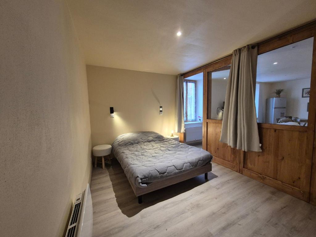 a bedroom with a bed in a room with a window at T2 BOURGEAT - Charmant 2 pièces - Centre ville in Bourg-Saint-Maurice