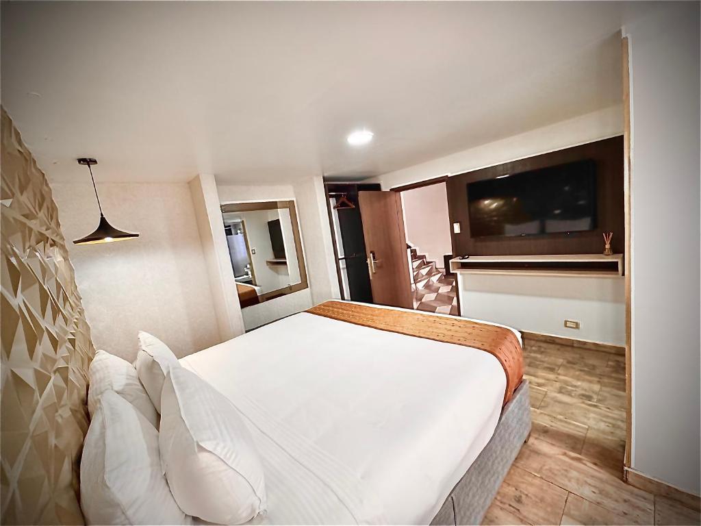 Postel nebo postele na pokoji v ubytování Hotel American Visa Normandia