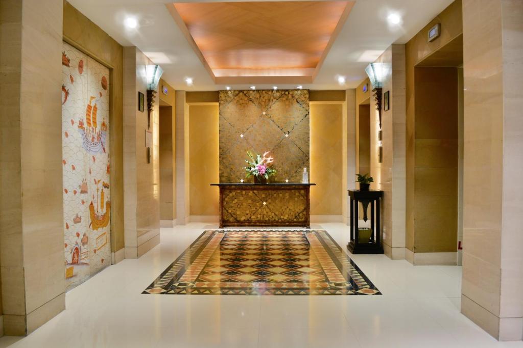 A polished elevator lobby with marble flooring and a decorative reception console.