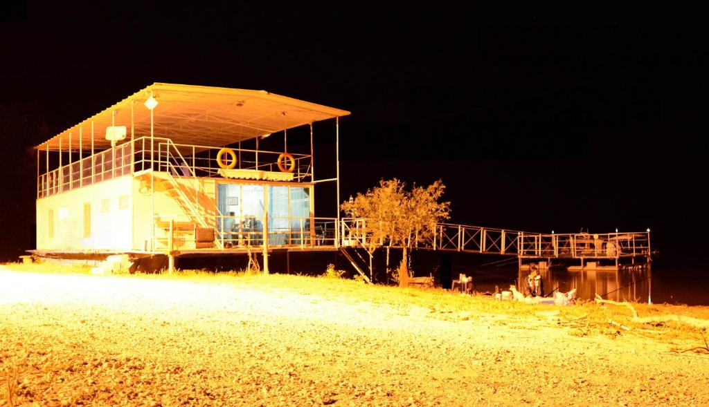 a building on the side of a road at night at Delta Pontoon in Mahmudia