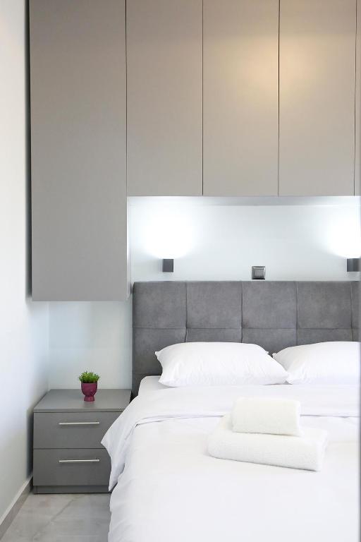a bedroom with a large white bed with white pillows at #Ioanna Apartments Unique in Thessaloniki
