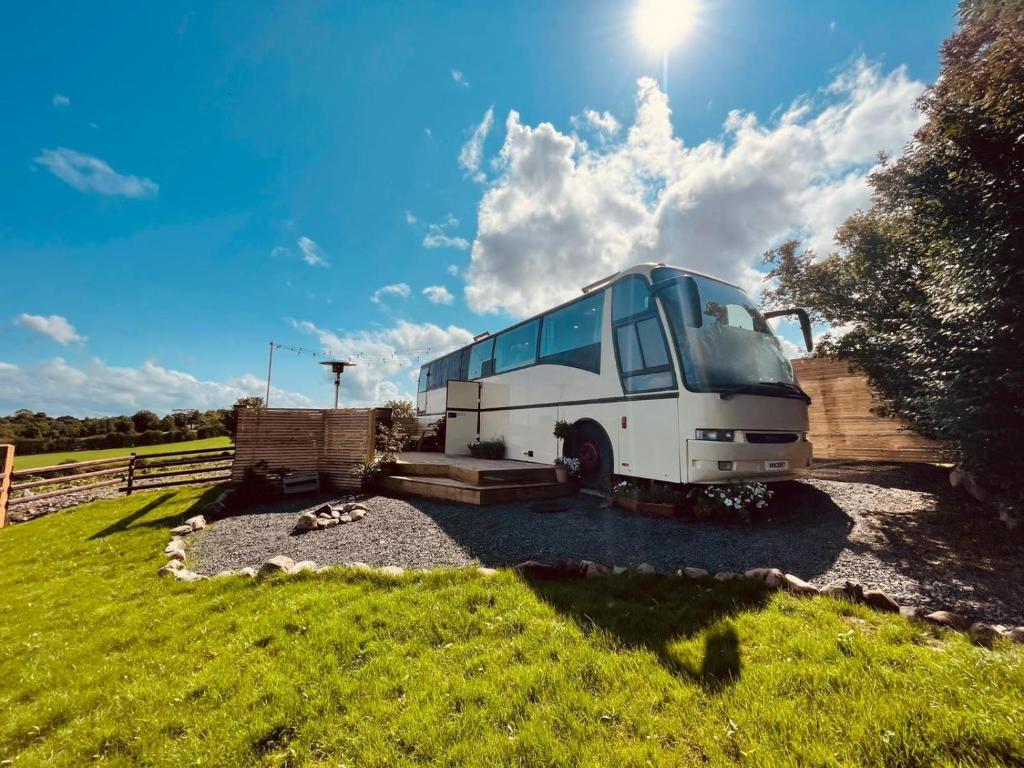 a truck parked in a field with the sun behind it at Vincent in Ballybogy