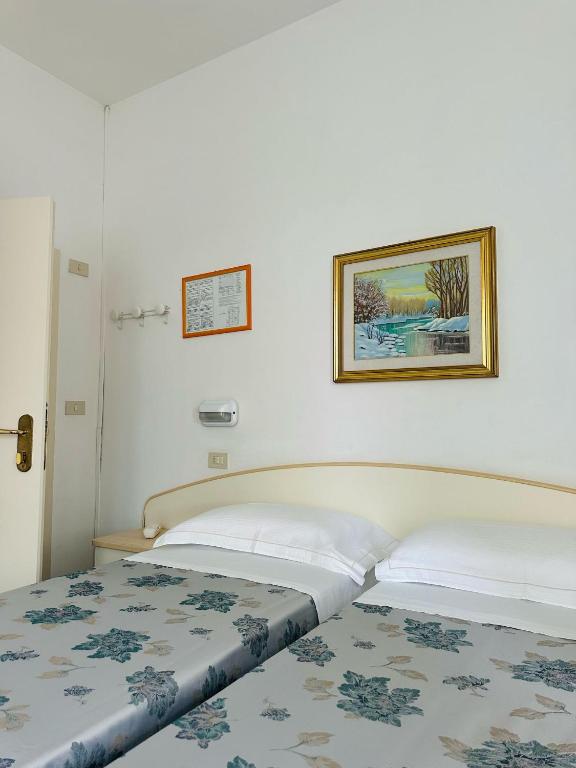 Postel nebo postele na pokoji v ubytování Hotel Erika