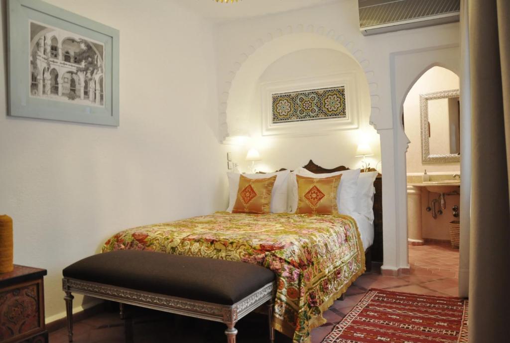 a bedroom with a bed in a room at Riad Cherifa in Chefchaouene