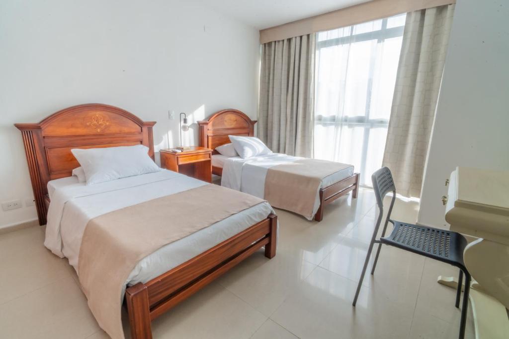 Postel nebo postele na pokoji v ubytování Suite House Juanambu