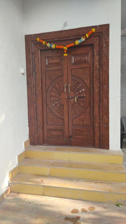 a large wooden door with stairs in front at OTP holiday homes in Kīhīm