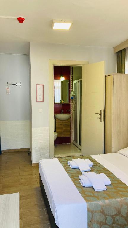 Postel nebo postele na pokoji v ubytování Bybassios Orhaniye