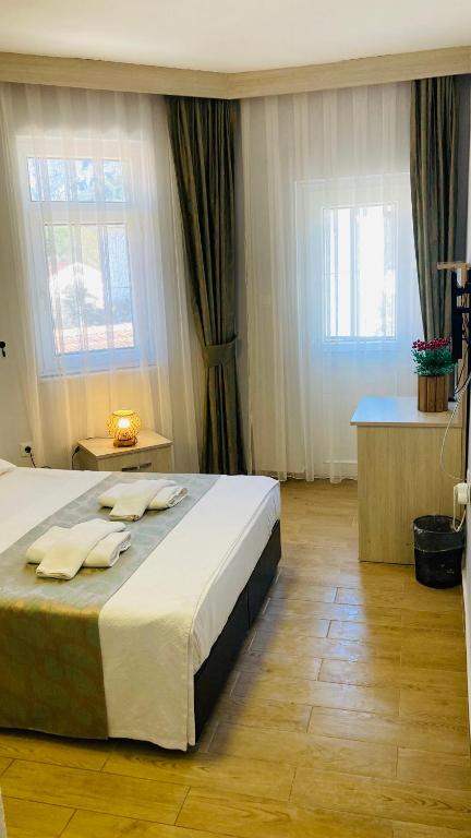Postel nebo postele na pokoji v ubytování Bybassios Orhaniye