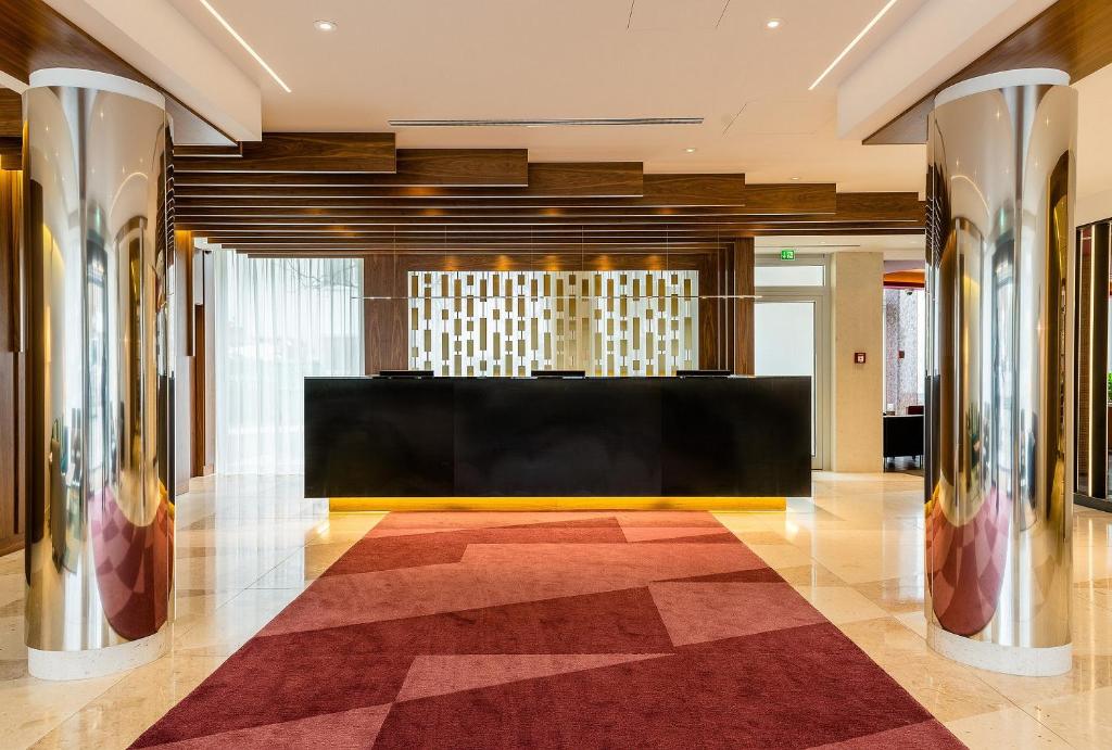 a lobby with a reception desk in a building at Hotel Europa in Munich