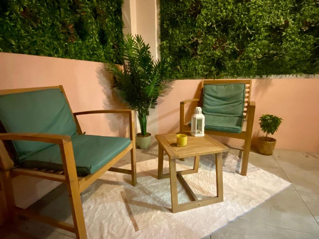 2 chaises et une table avec une bouteille. dans l'établissement Studio Bricka - 200m to the beach, parking, clim, terrace, à Antibes