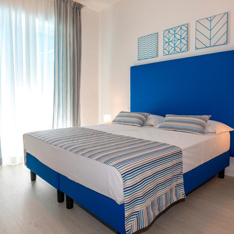 Postel nebo postele na pokoji v ubytování Hotel Paolina
