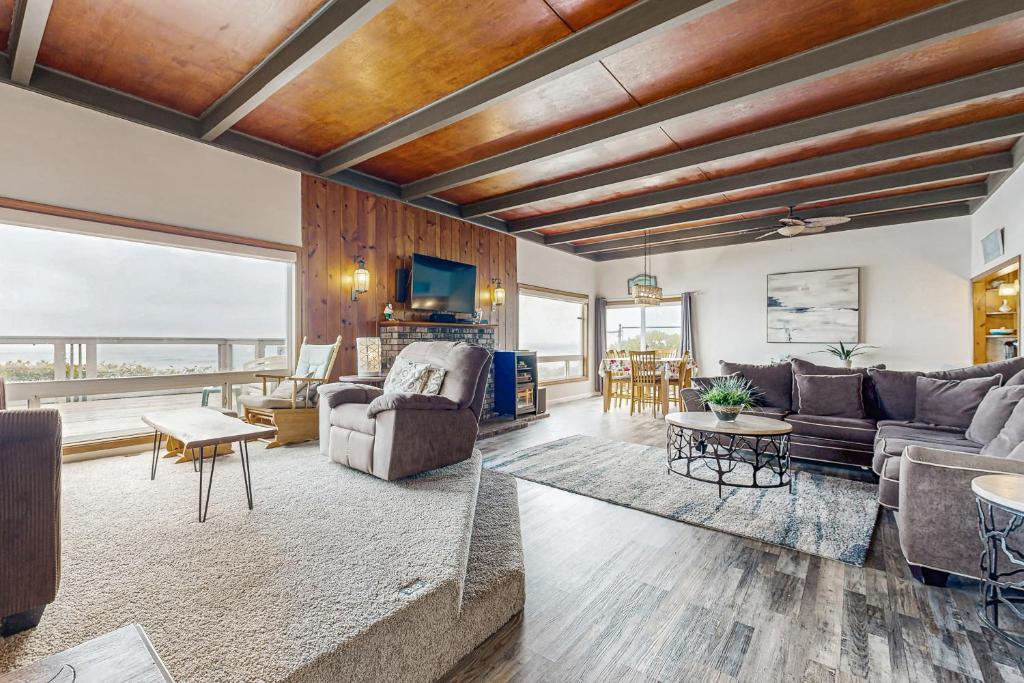 a living room with a couch and a table at Gleneden BeachFront Getaway in Lincoln Beach