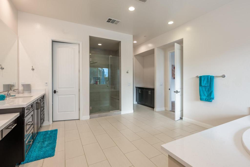 a large bathroom with a sink and a shower at Coachella Dream - Luxury Mid-Term Rental in Indio