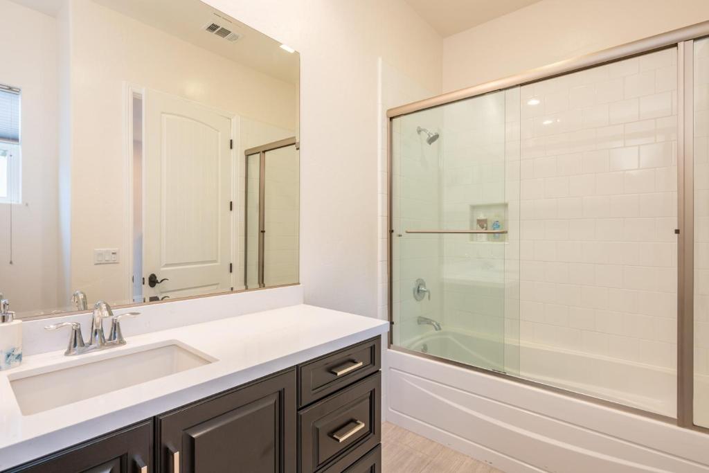a bathroom with a sink and a shower at Coachella Dream - Luxury Mid-Term Rental in Indio