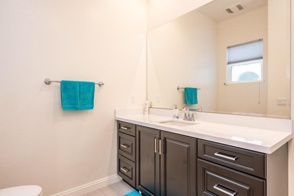 a bathroom with a sink and a mirror at Coachella Dream - Luxury Mid-Term Rental in Indio