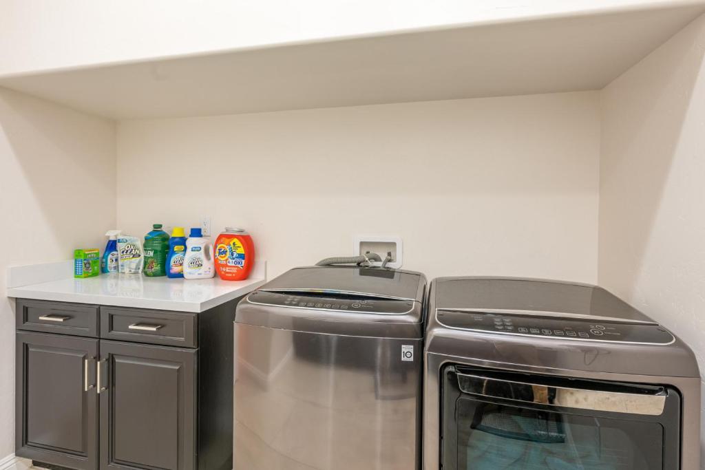 a kitchen with a stove and a counter top at Coachella Dream - Luxury Mid-Term Rental in Indio