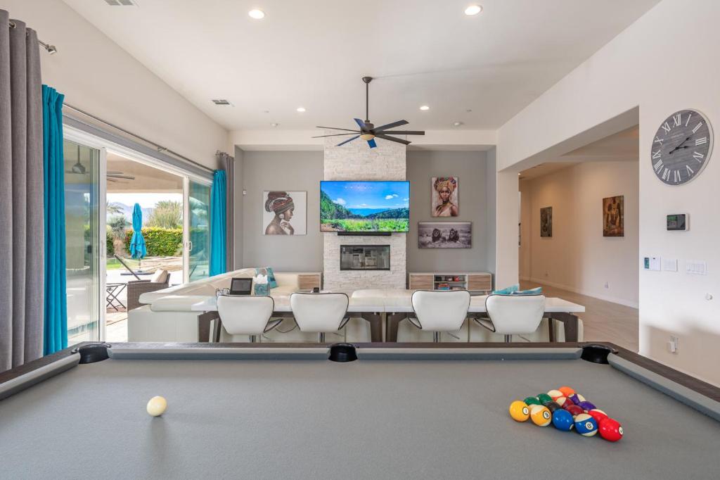 a living room with a pool table at Coachella Dream - Luxury Mid-Term Rental in Indio