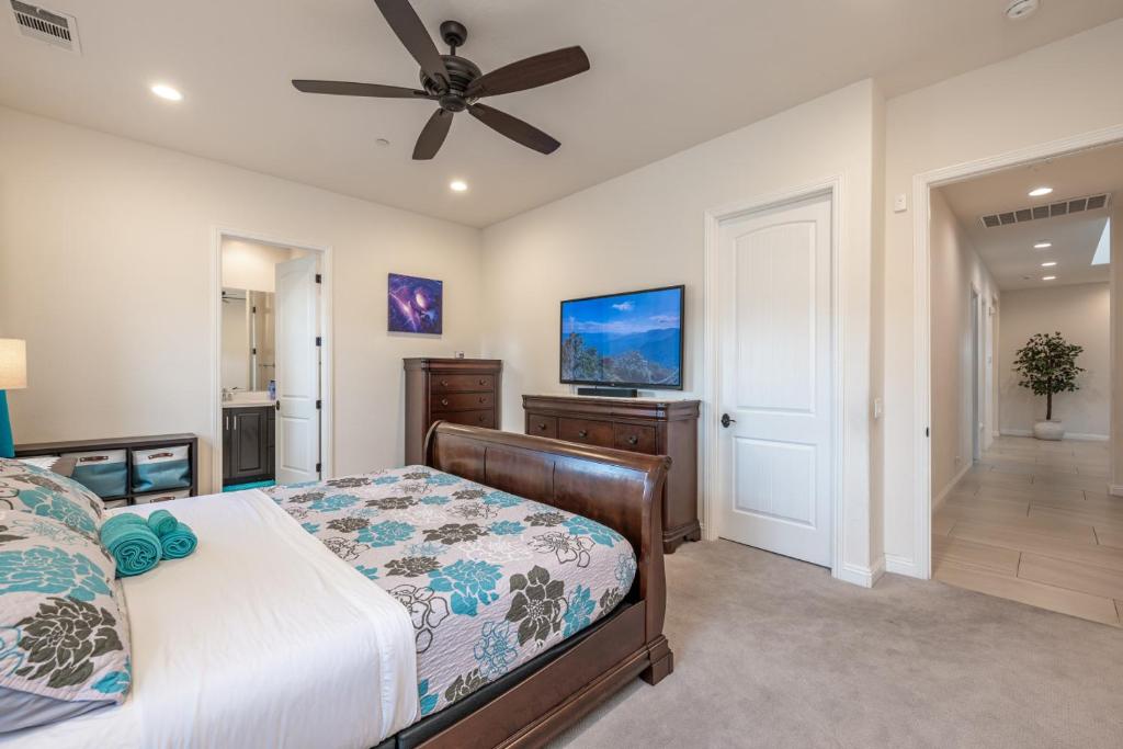a bedroom with a bed and a ceiling fan at Coachella Dream - Luxury Mid-Term Rental in Indio