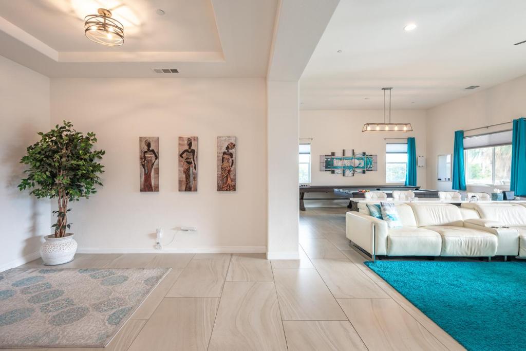 a living room with a white couch and a blue rug at Coachella Dream - Luxury Mid-Term Rental in Indio