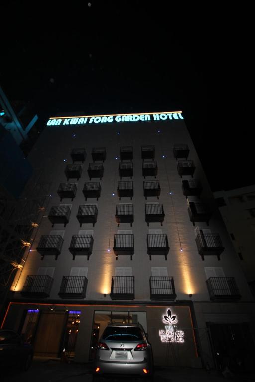 a car parked in front of a hotel at night at Lan Kwai Fong Garden Hotel in Chiayi City