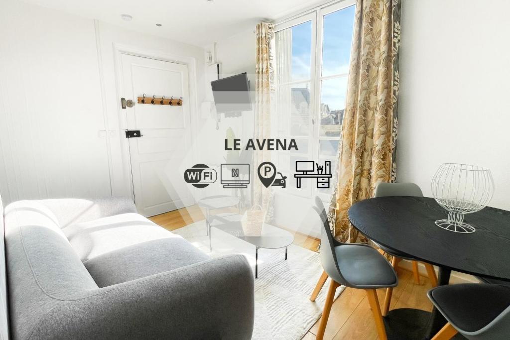 a living room with a couch and a table at Le Avena - Centre Ville - Calme - Cour in Saumur